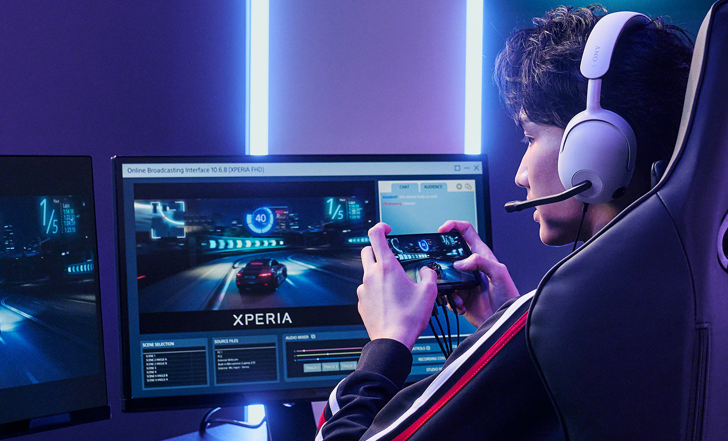 A pro gamer wearing a headset, playing on Xperia 1 IV Gaming Edition connected to two monitors